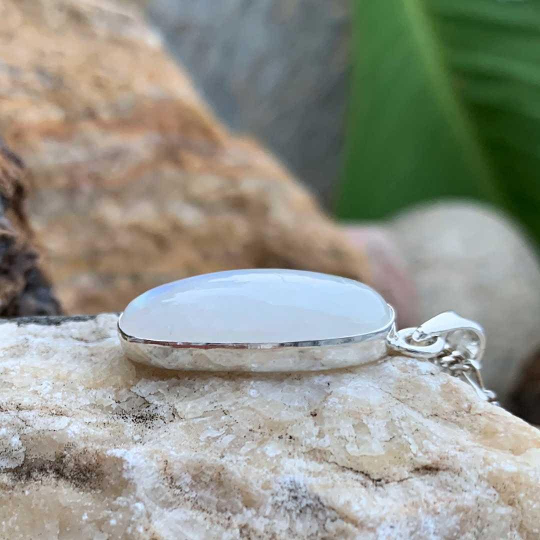 an image of a side view of an Oblong Rainbow Moonstone and Sterling Silver Pendant
