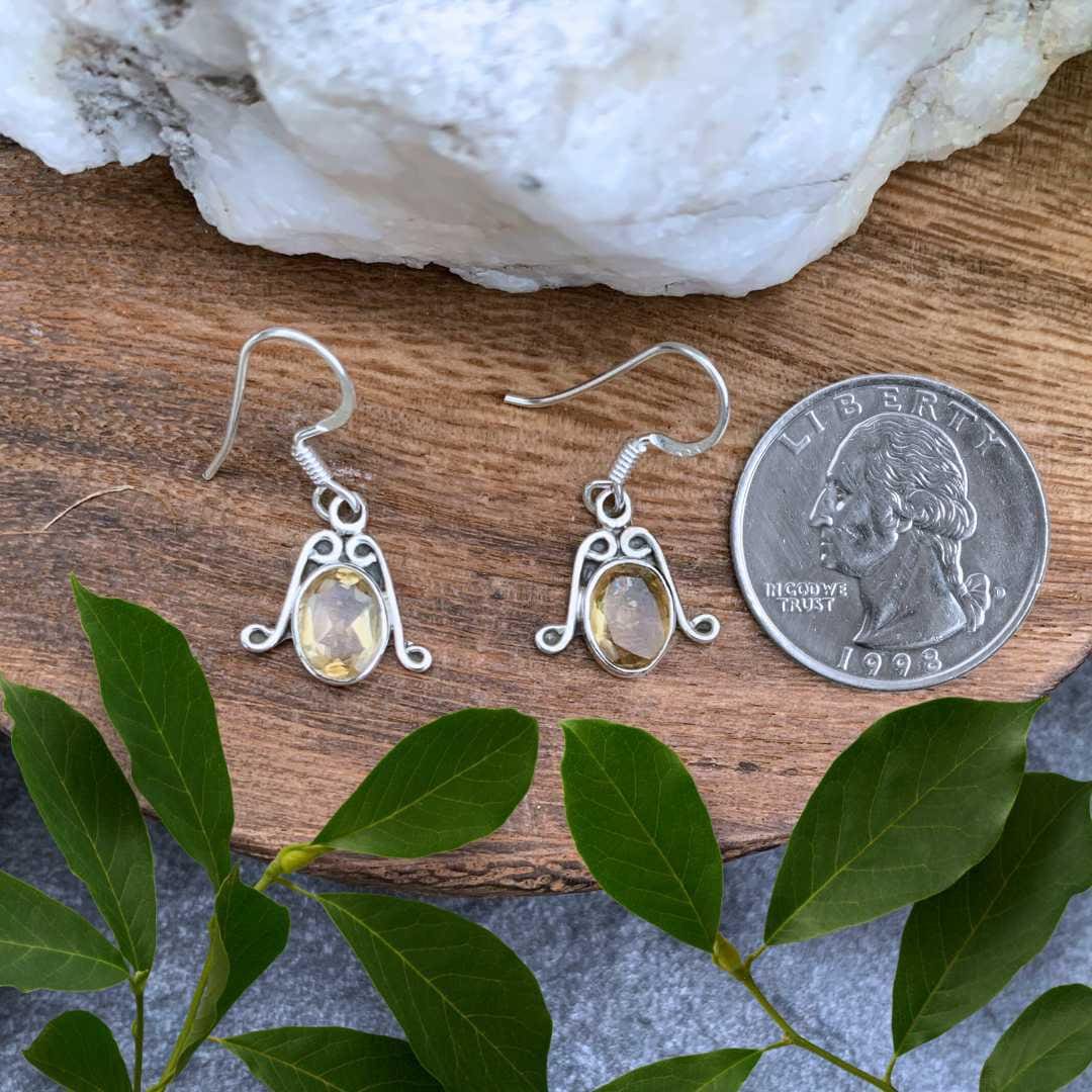 an image of a pair of Oval Faceted Citrine and Sterling Silver Earrings next to a quarter