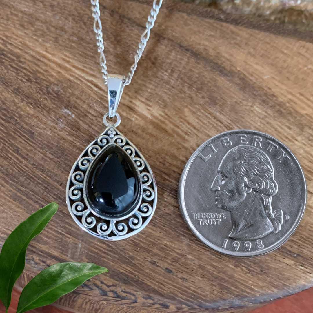 an image of a Teardrop Black Onyx Filigree Sterling Silver Pendant next to a quarter