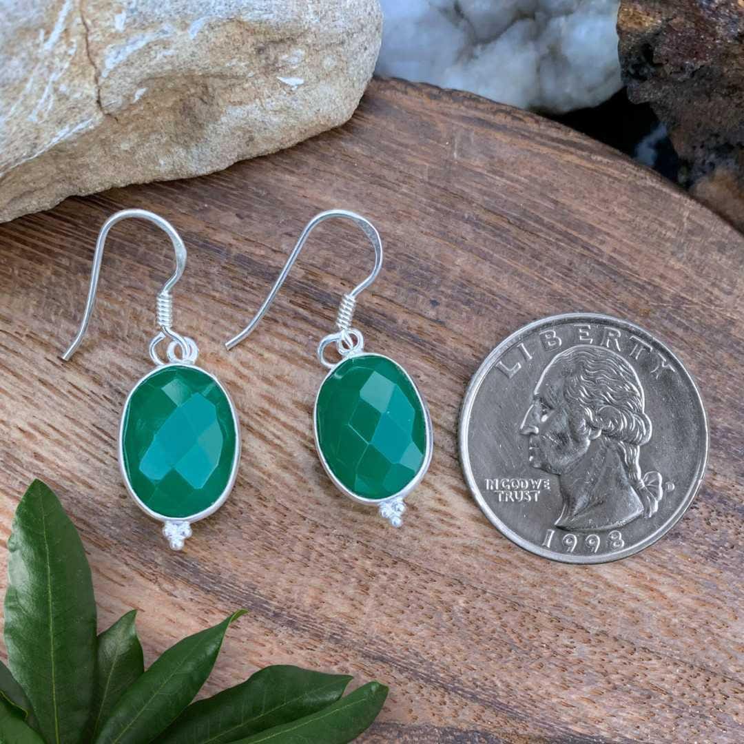 an image of a pair of Oval Faceted Green Onyx and Sterling Silver Earrings next to a quarter