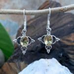 an image of a pair of Ornate Sterling Silver and Oval Citrine Earrings. These earrings have a subtle dangle