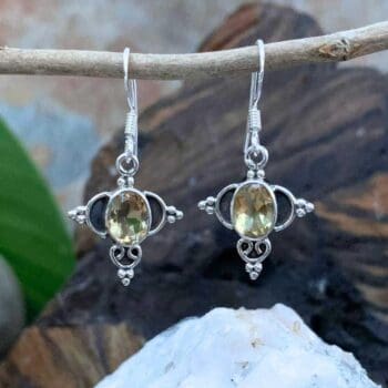 an image of a pair of Ornate Sterling Silver and Oval Citrine Earrings. These earrings have a subtle dangle