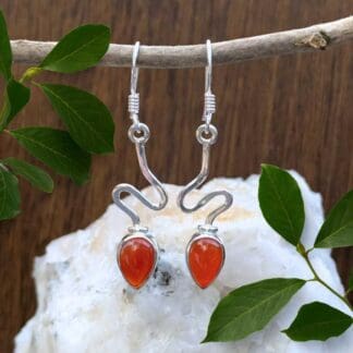 an image of a pair of Contemporary Sterling Silver and Carnelian Teardrop Earrings with a zig zag section of sterling above a teardrop carnelian cabochon