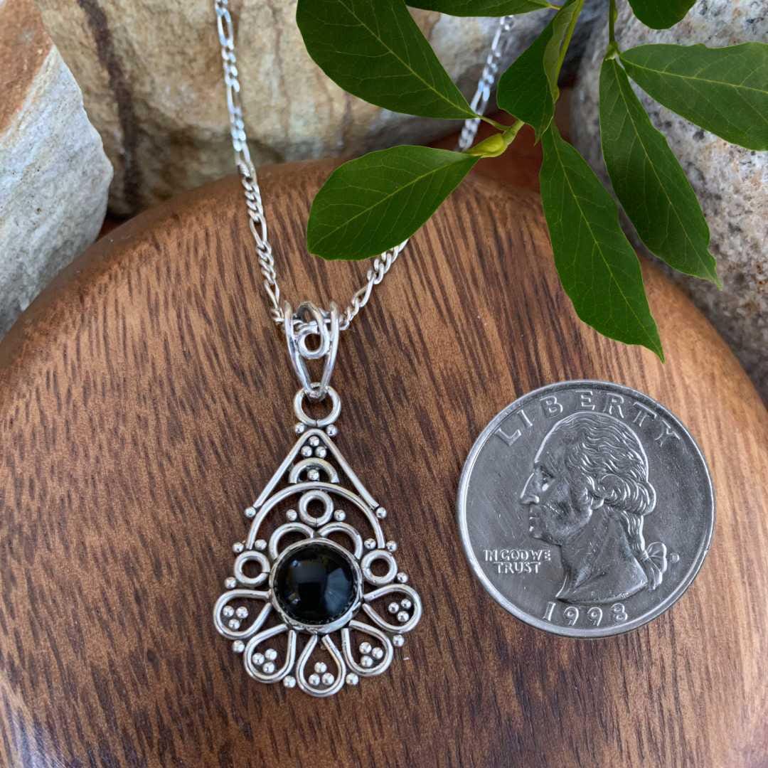 an image of a Feminine Filigree Sterling Silver and Black Onyx Pendant next to a quarter