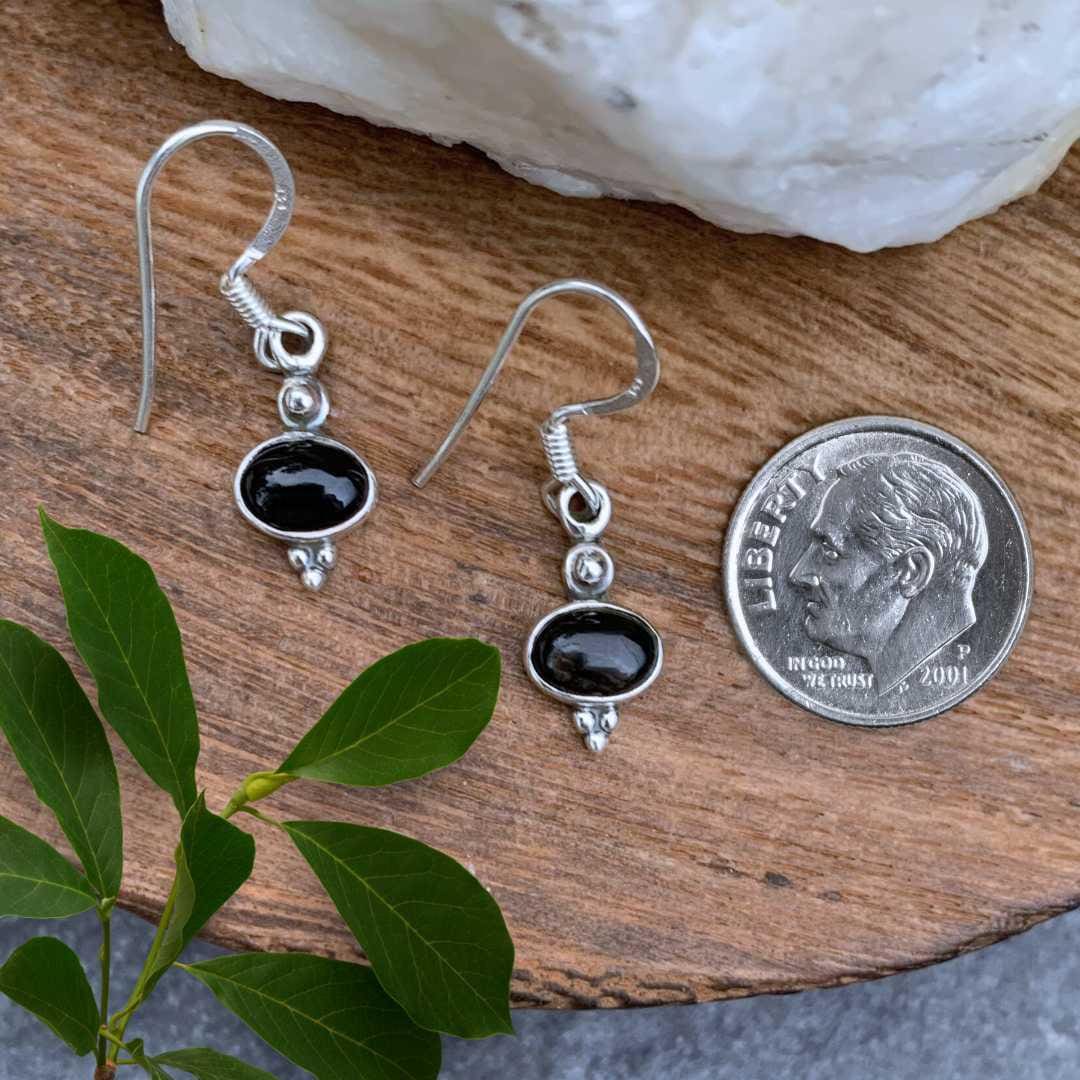 an image of a pair of Dainty Oval Black Onyx and Sterling Silver Earrings next to a dime