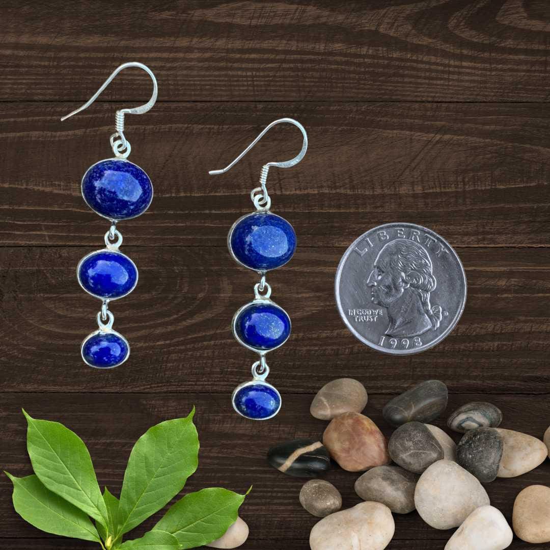 an image of a pair of Triple Oval Lapis Lazuli and Sterling Silver Dangle Earrings next to a quarter