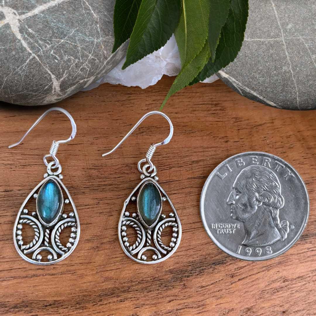 an image of a pair of Oval Filigree Sterling Silver with Marquise Labradorite Earrings next to a quarter