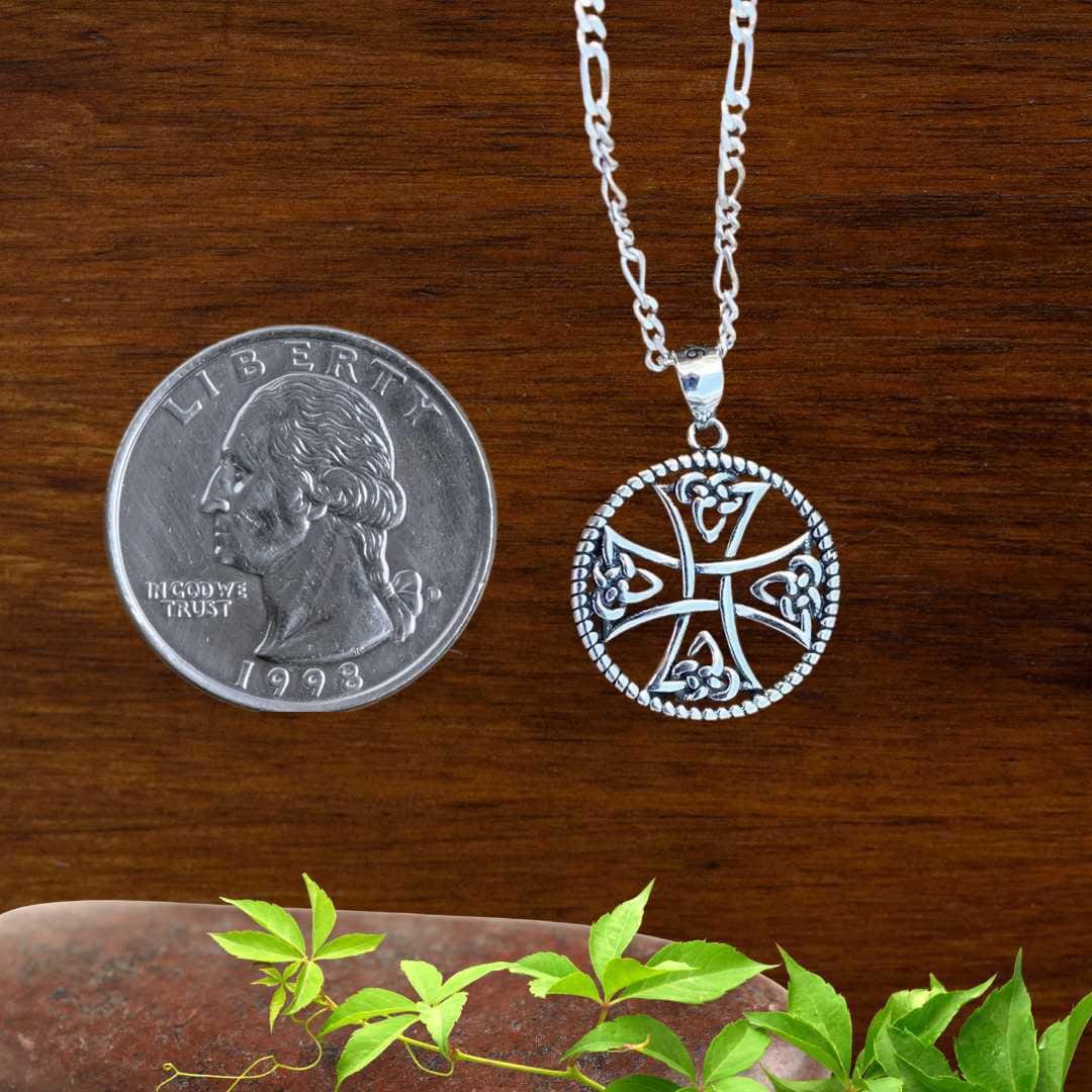 an image of a round Celtic Cross Sterling Silver Pendant next to a quarter
