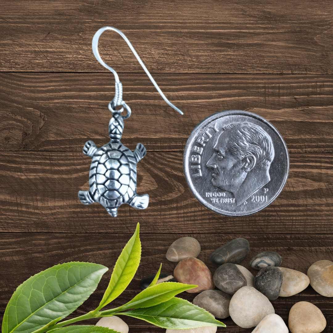 an image of a Sterling Silver Turtle Dangle Earring next to a dime