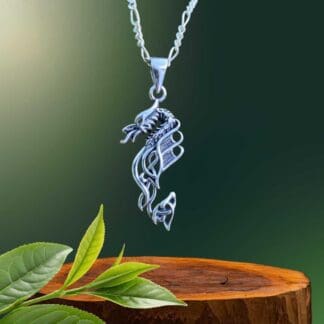 an image of a vertical designed sterling silver dragon pendant with fire out of the mouth and some celtic knots in the design