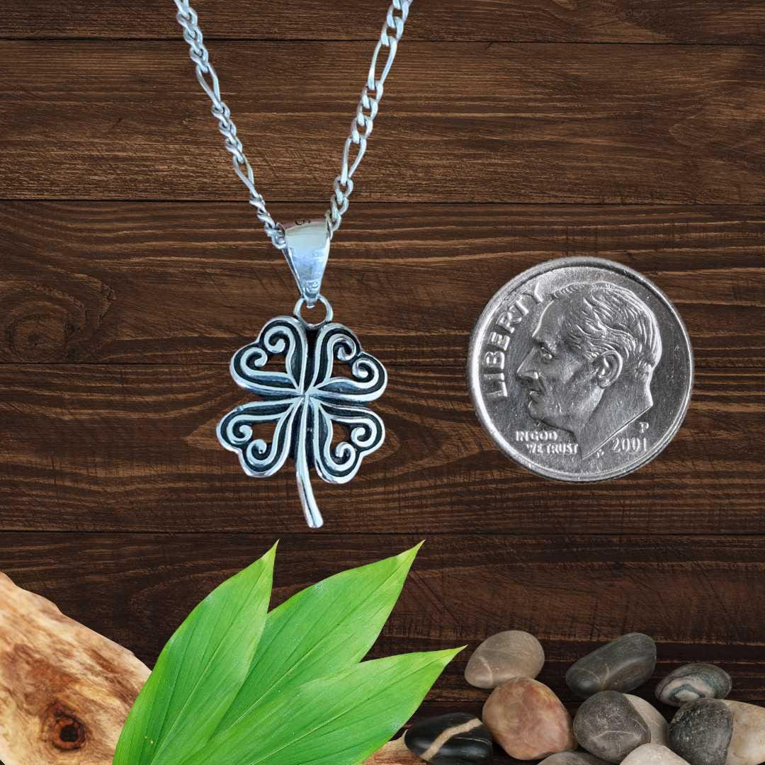 an image of a pair of Sterling Silver Four Leaf Hearts Clover Pendant next to a dime