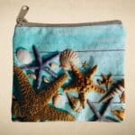 an image of a Seashells and Starfish Coin Purse made of heavy cotton canvas type material and a zipper.