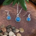 an image of a Sterling Silver and Blue Chalcedony Pendant and Earrings Set with a dainty round pendant and matching slightly smaller round dangle earrings.