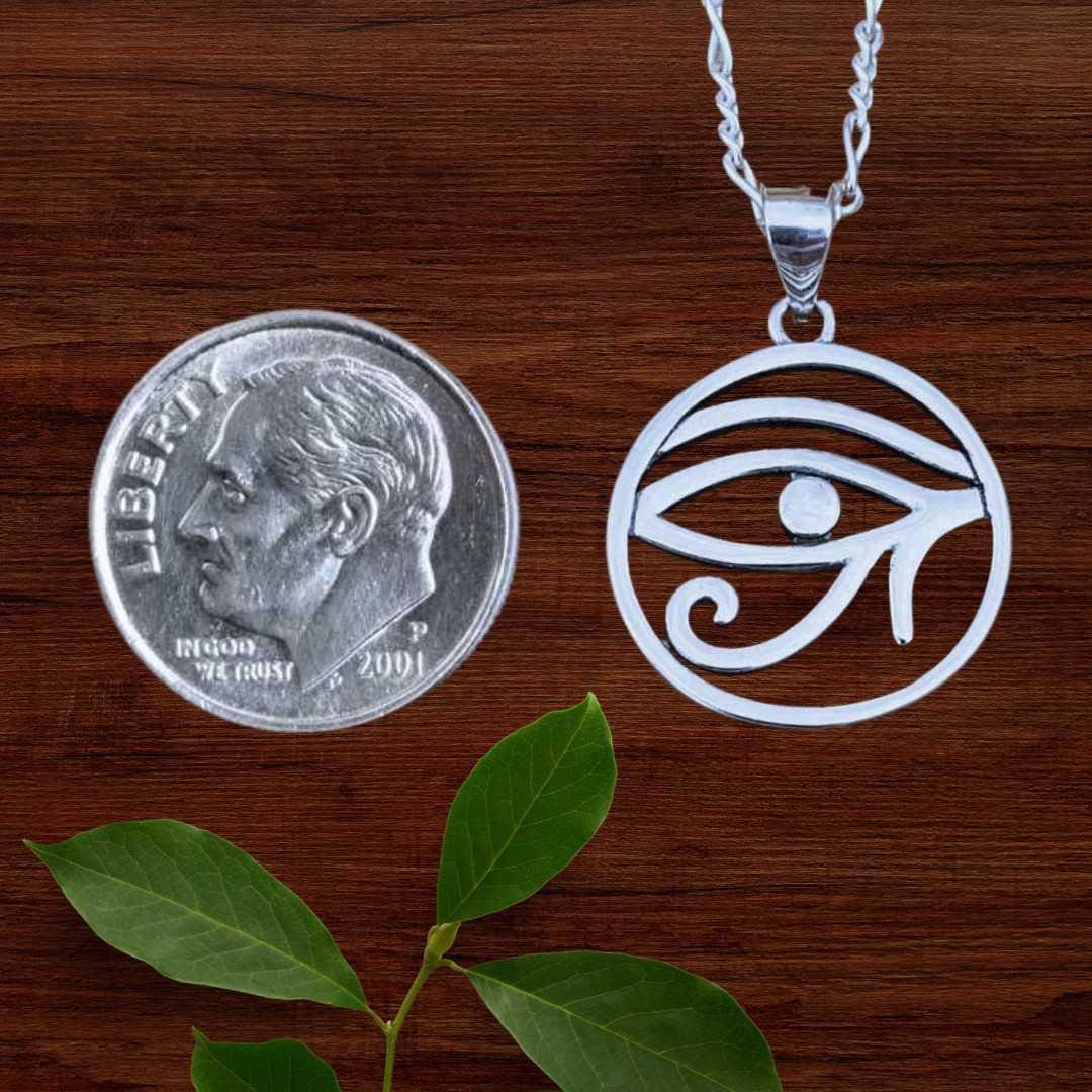 an image of an Sterling Silver Eye of Horus Pendant next to a dime