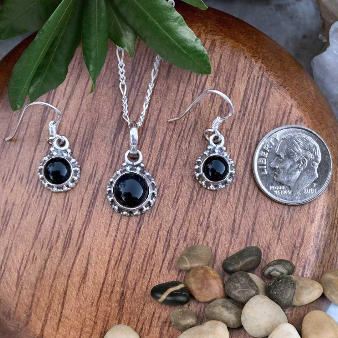 an image of a Dainty Sterling Silver and Black Onyx Pendant and Earrings Set next to a dime