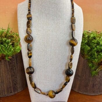 an image of a tiger's eye gemstone beaded necklace featuring large round beads mixed with a variety of other shapes.