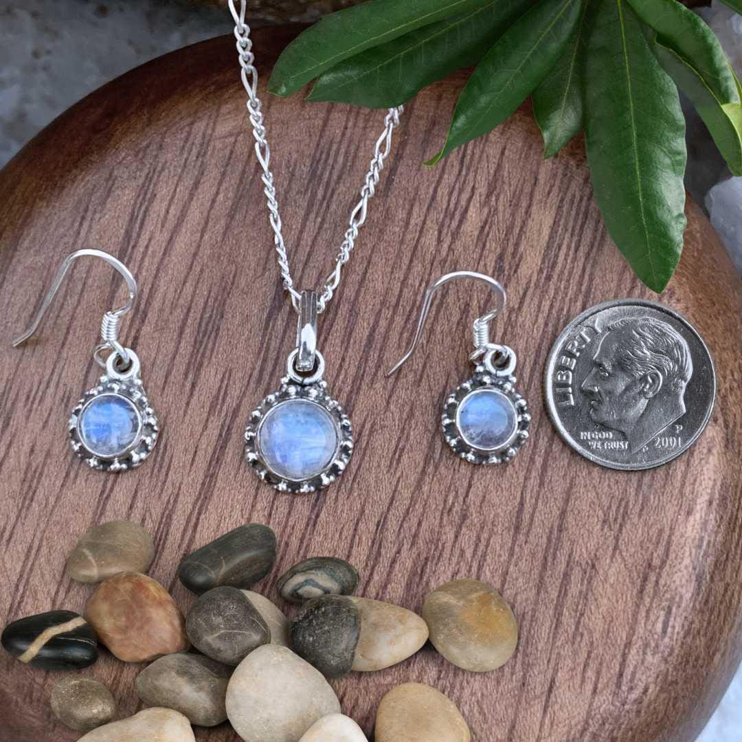 an image of a Rainbow Moonstone and Sterling Silver Pendant and Earrings Set next to a dime