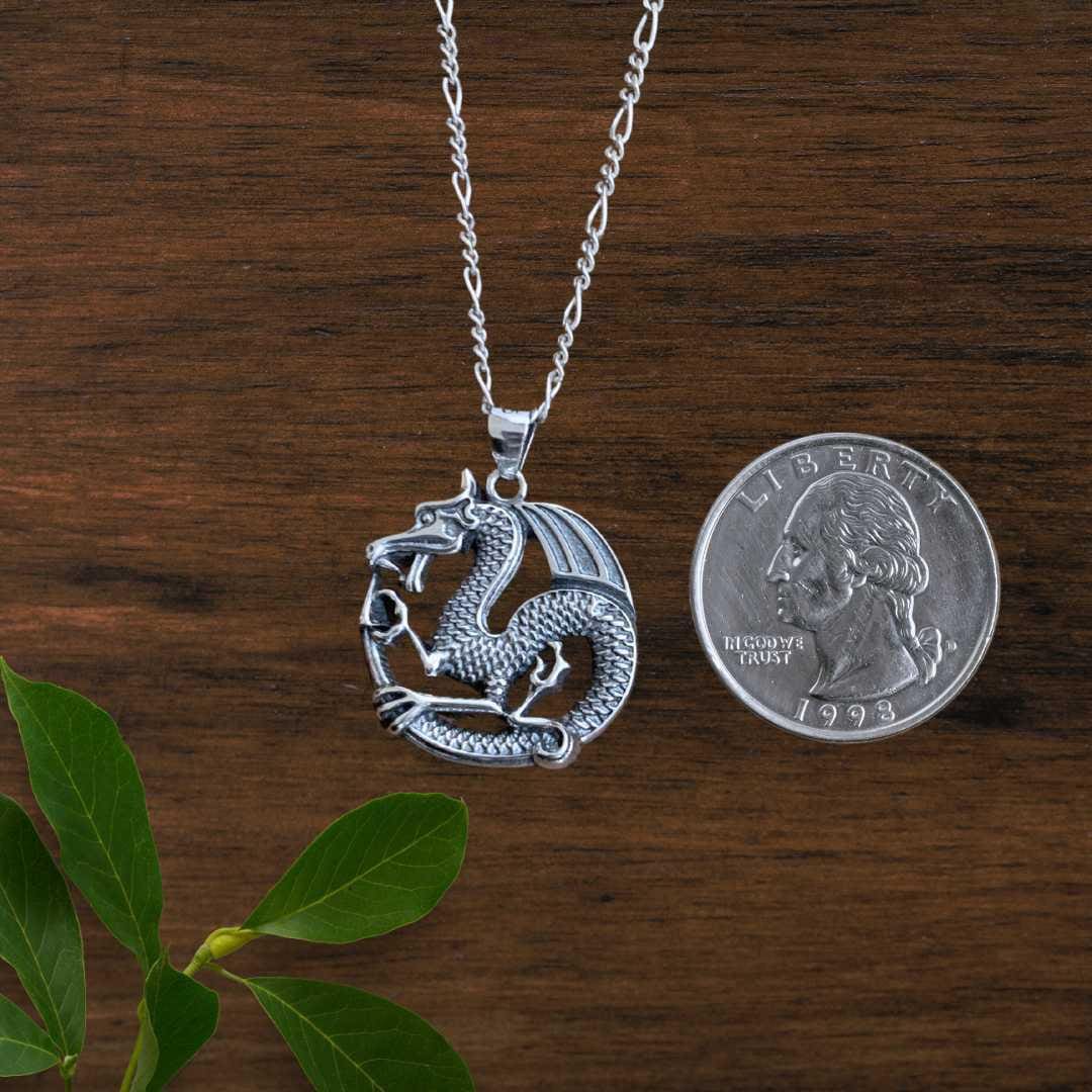an image of a Bold Sterling Silver Dragon Pendant next to a quarter