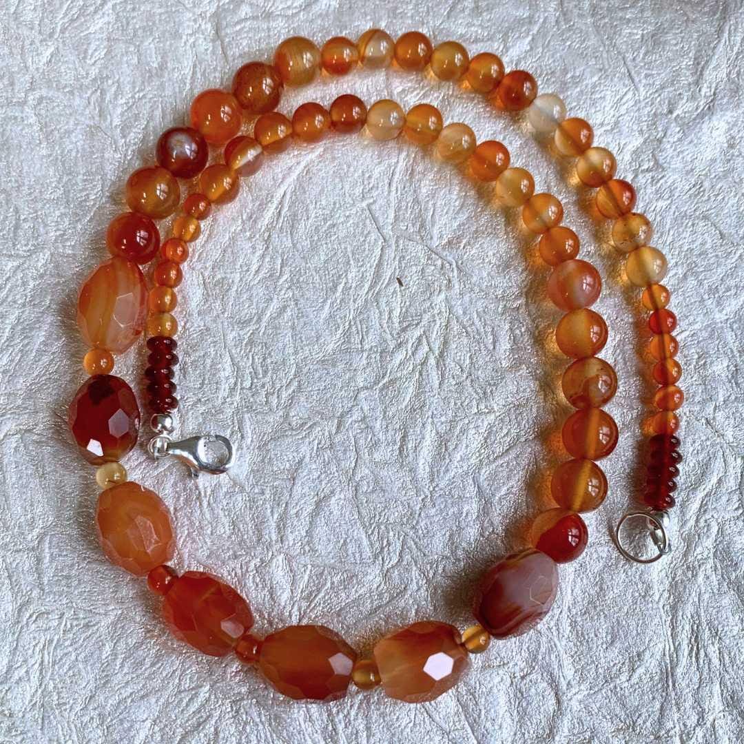 an image of a Faceted Oval Barrels Carnelian Beaded Necklace in a circle