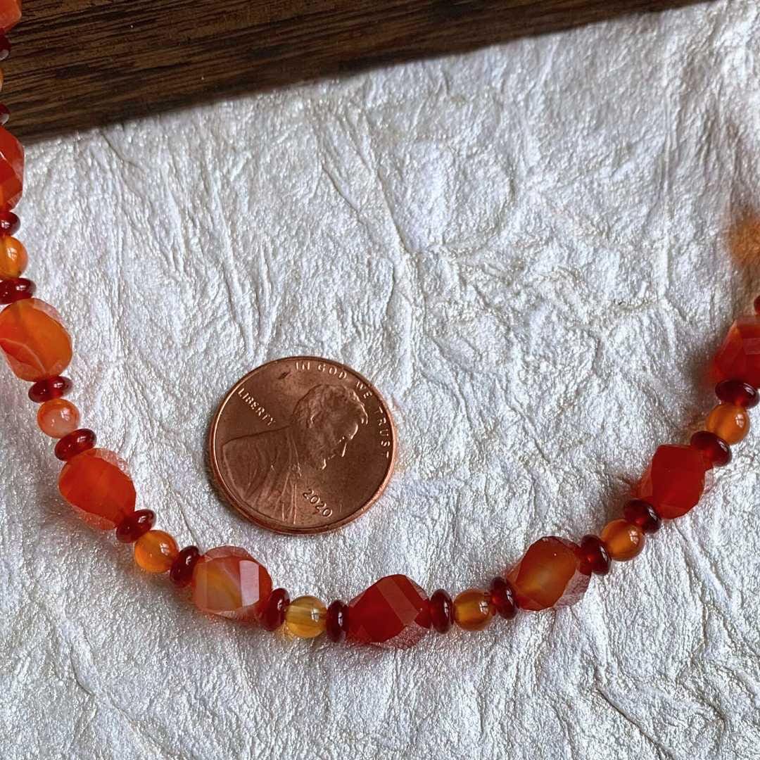 an image of a 19" long Mixed Carnelian Beaded Necklace next to a penny