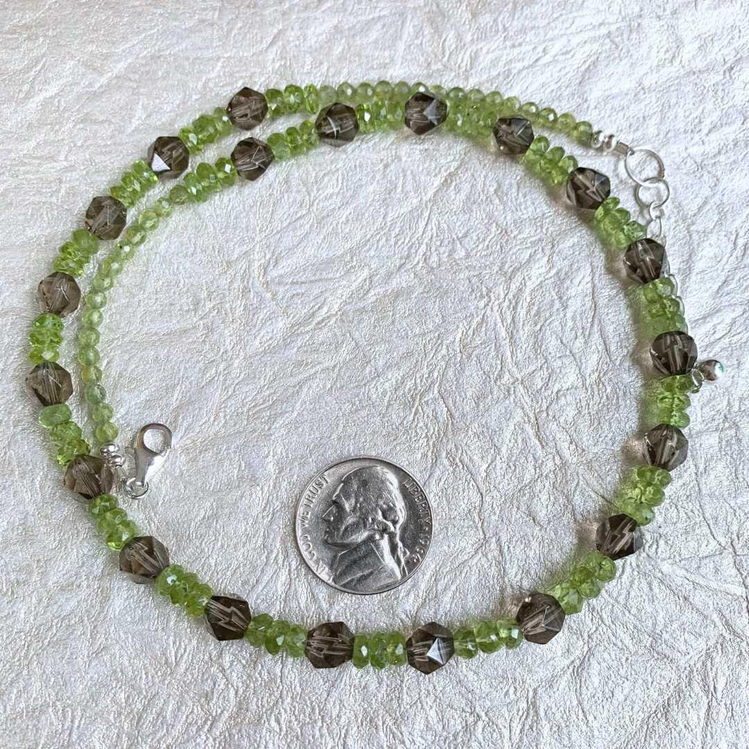 an image of a Peridot and Faceted Smoky Quartz Beaded Necklace in a circle next to a nickel