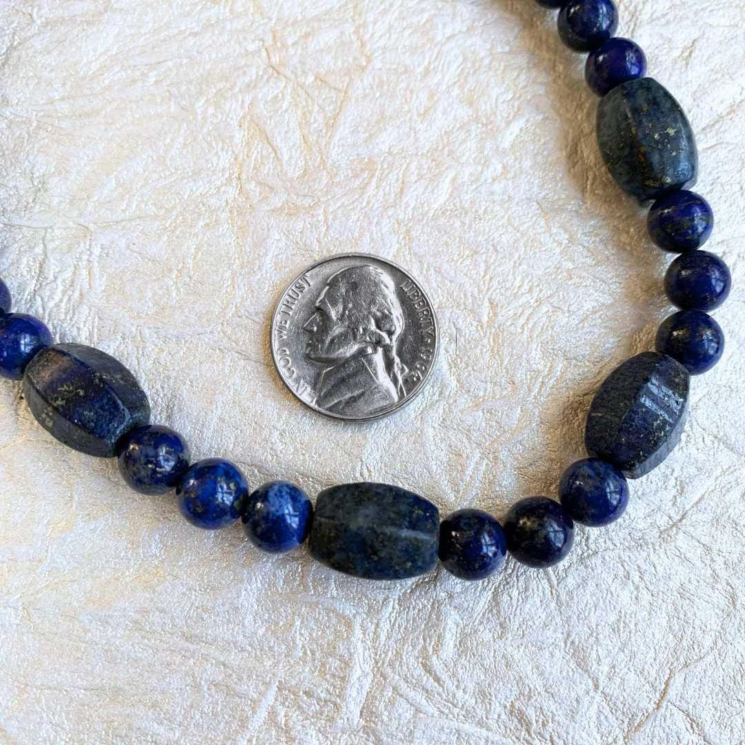 an image of a Lapis Lazuli Melon Barrel Mixed Bead Necklace that is 24.5 inches long and shows the beads next to a nickel