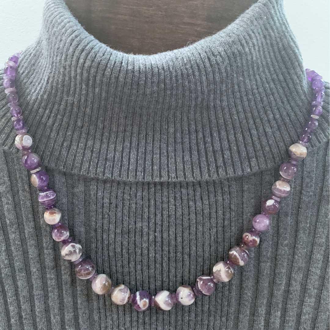 an image of a Amethyst and Chevron Amethyst Beaded Necklace worn over a grey turtleneck sweater