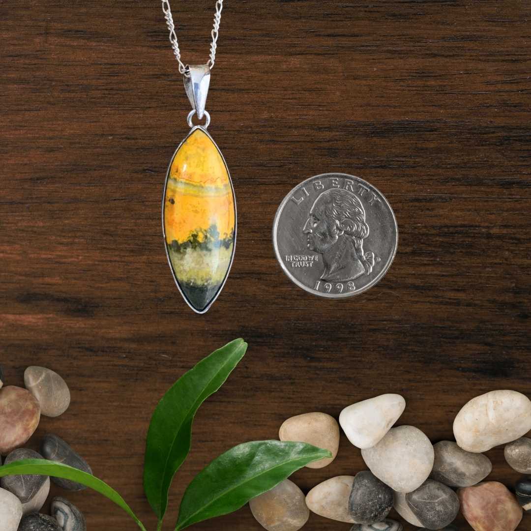 an image of a Marquise Bumblebee Jasper and Sterling Silver Pendant next to a quarter