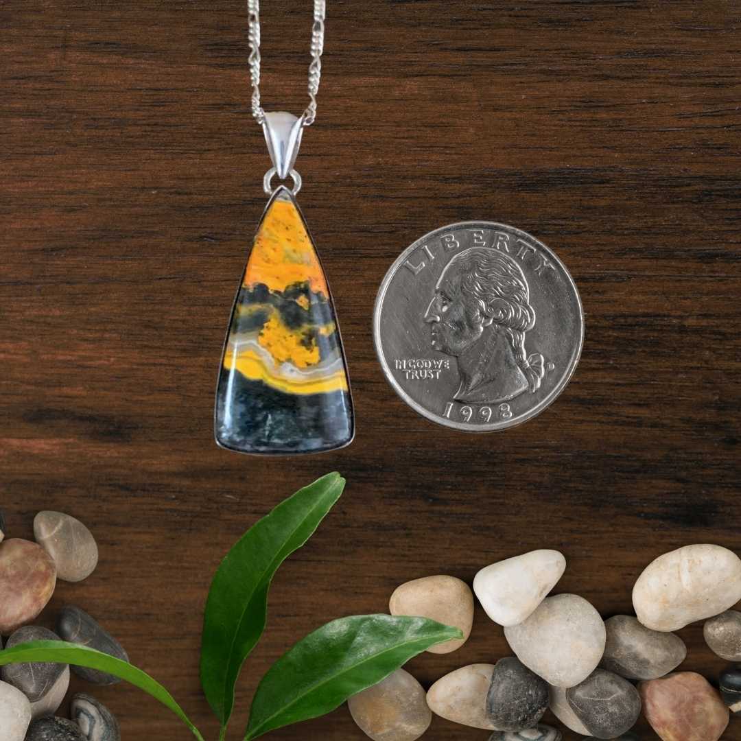 an image of a Triangle Bumblebee Jasper and Sterling Silver Pendant next to a quarter