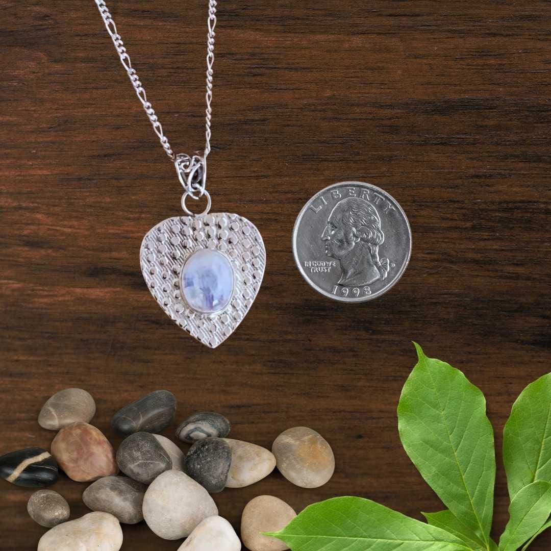an image of a Rainbow Moonstone and Sterling Silver Heart Pendant next to a quarter