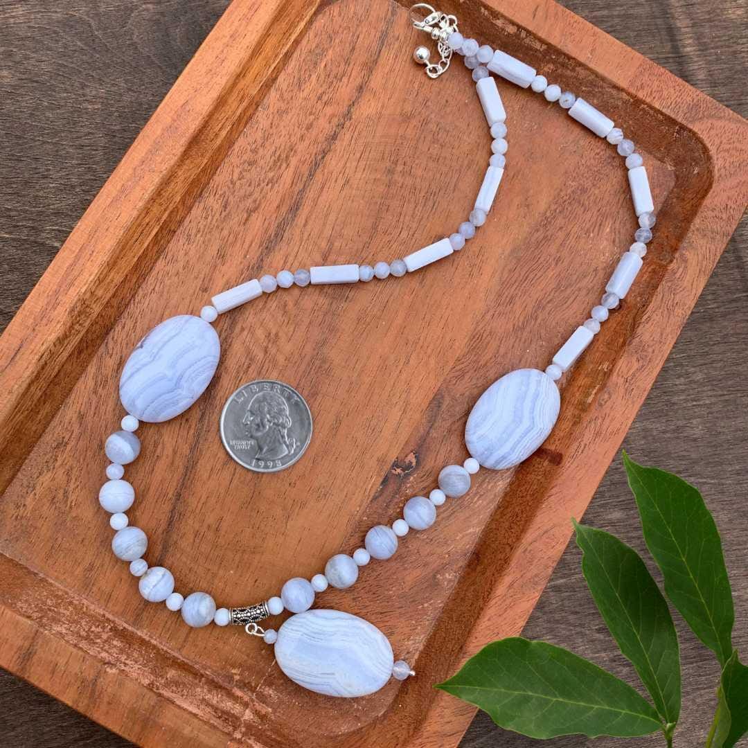 an image of a Blue Lace Agate Statement Necklace next to a quarter