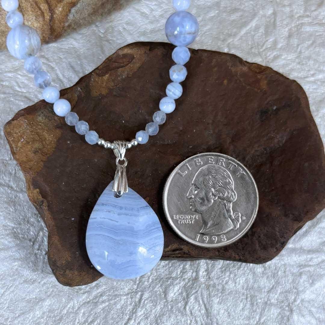 an image of a Blue Lace Agate Necklace and Pendant next to a quarter