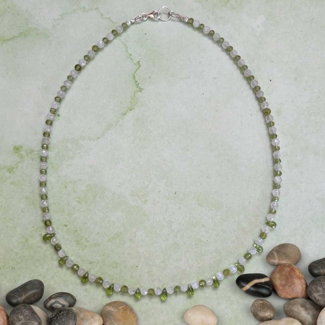 an image of a dainty Faceted Peridot and Rainbow Moonstone Necklace with 4mm faceted rainbow moonstone and peridot beads and eleven faceted small teardrop Peridot beads as focal pieces