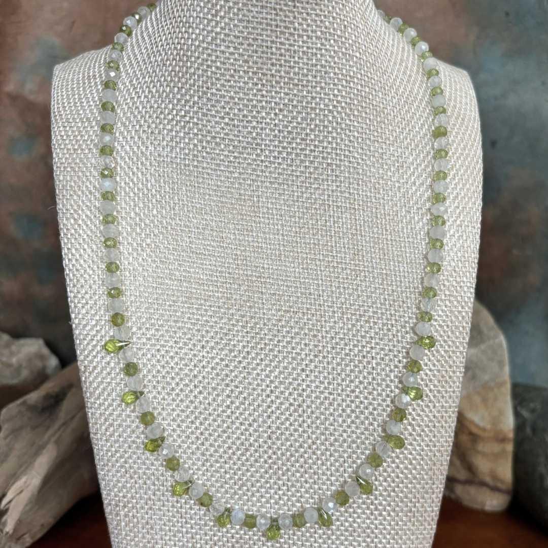 an image of a dainty Faceted Peridot and Rainbow Moonstone Necklace with 4mm faceted rainbow moonstone and peridot beads and eleven faceted small teardrop Peridot beads as focal pieces