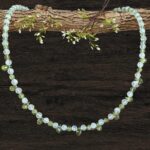 an image of a dainty Faceted Peridot and Rainbow Moonstone Necklace with 4mm faceted rainbow moonstone and peridot beads and eleven faceted small teardrop Peridot beads as focal pieces