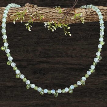 an image of a dainty Faceted Peridot and Rainbow Moonstone Necklace with 4mm faceted rainbow moonstone and peridot beads and eleven faceted small teardrop Peridot beads as focal pieces