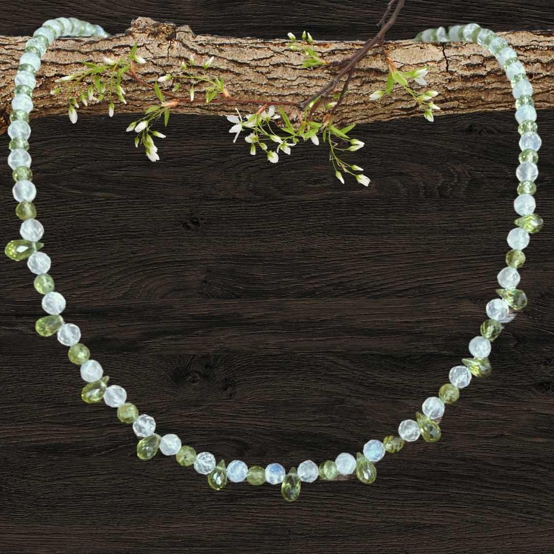 an image of a dainty Faceted Peridot and Rainbow Moonstone Necklace with 4mm faceted rainbow moonstone and peridot beads and eleven faceted small teardrop Peridot beads as focal pieces
