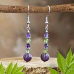 an image of a pair od Atlantisite Stichtite with Peridot and Amethyst beaded gemstone dangle Earrings
