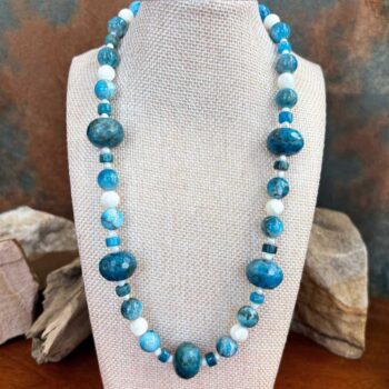 an image of a Mixed Apatite with Mother of Pearl Beaded Necklace featuring 18mm faceted rondelle apatite beads mixed with round and heishi shaped blue apatite beads with round mother of pearl beads.