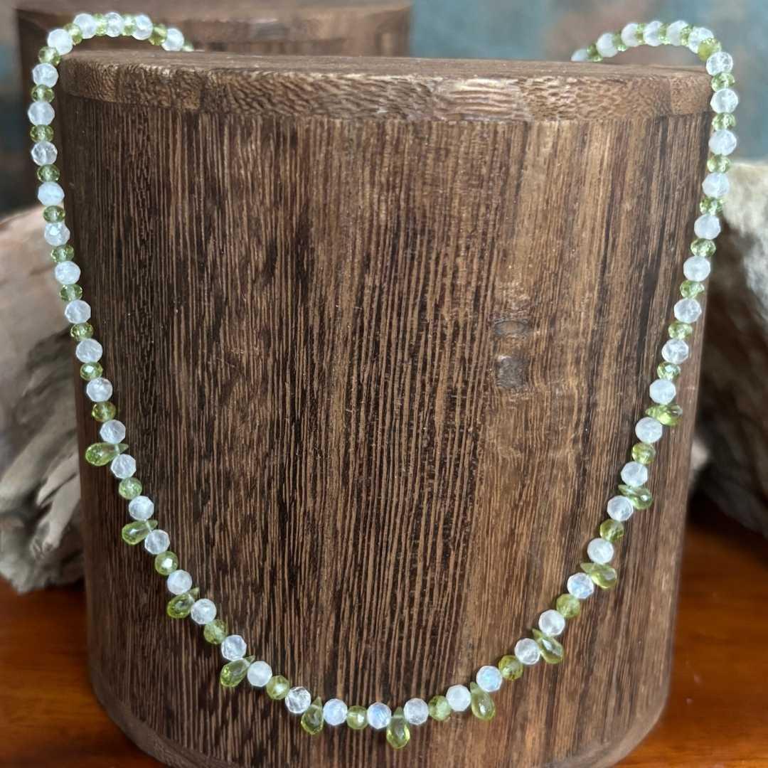 an image of a dainty Faceted Peridot and Rainbow Moonstone Necklace with 4mm faceted rainbow moonstone and peridot beads and eleven faceted small teardrop Peridot beads as focal pieces