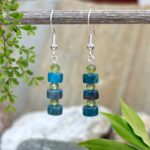 an image of a pair of Apatite Heishi and Faceted Peridot Earrings with three apatite Heishi beads and three 4mm faceted peridot earrings in a stack design on a sterling silver ear hook