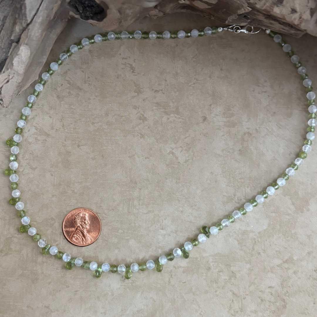 an image of a dainty Faceted Peridot and Rainbow Moonstone Necklace with 4mm faceted rainbow moonstone and peridot beads and eleven faceted small teardrop Peridot beads as focal pieces