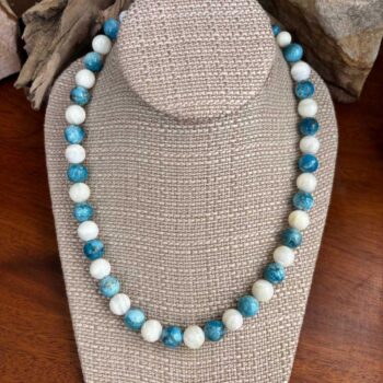 an image of a Round Apatite and Mother of Pearl Beaded Necklace with alternating apatite and mother of pearl beads that are each 10mm in size. It is finished off with sterling beads and lobster clasp