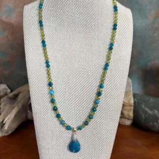 an image of a faceted Apatite and Peridot Beaded Necklace with teardrop shaped Apatite Pendant on sterling silver bail. Pendant has a 1 inch total drop and half an inch wide.