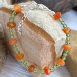 an image of a Carnelian and Peridot Beaded Bracelet with faceted rondelle carnelian beads alternating with trios of small peridot beads.