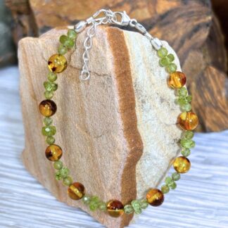 an image of a Faceted Peridot and Smooth Round Amber Beaded Bracelet finished off with sterling silver beads and lobster clasp with a 1.5 sterling silver extension chain.