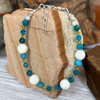 an image of a Mother of Pearl with Apatite and Peridot Beaded Bracelet finished with sterling silver beads and lobster clasp and 1.5 inch sterling silver extension chain