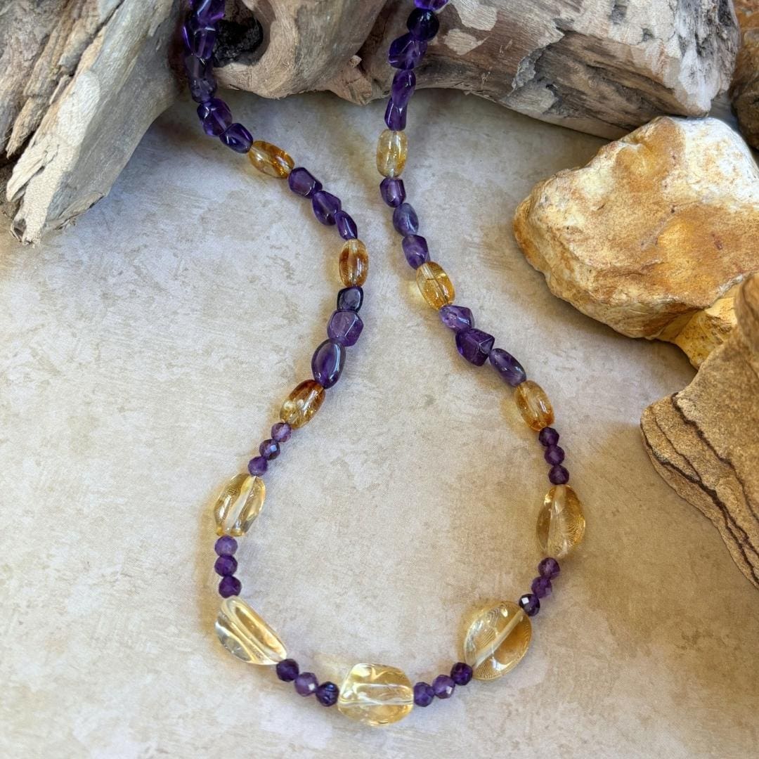 an image of a Citrine and Amethyst Beaded Necklace with citrine smooth nuggets, citrine barrel beads and 4 mm faceted amethyst and amethyst smooth nuggets. The necklace is 19.75 inches long