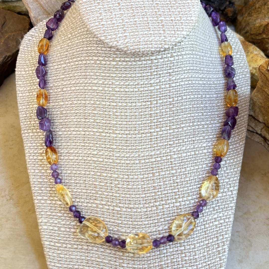 an image of a Citrine and Amethyst Beaded Necklace with citrine smooth nuggets, citrine barrel beads and 4 mm faceted amethyst and amethyst smooth nuggets. The necklace is 19.75 inches long