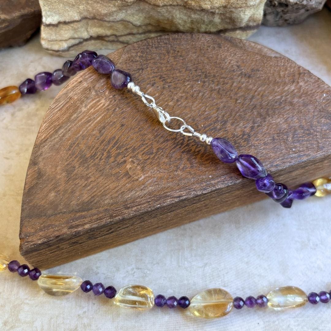 an image of a Citrine and Amethyst Beaded Necklace with citrine smooth nuggets, citrine barrel beads and 4 mm faceted amethyst and amethyst smooth nuggets. The necklace is 19.75 inches long. This image is a closeup of the sterling silver clasp